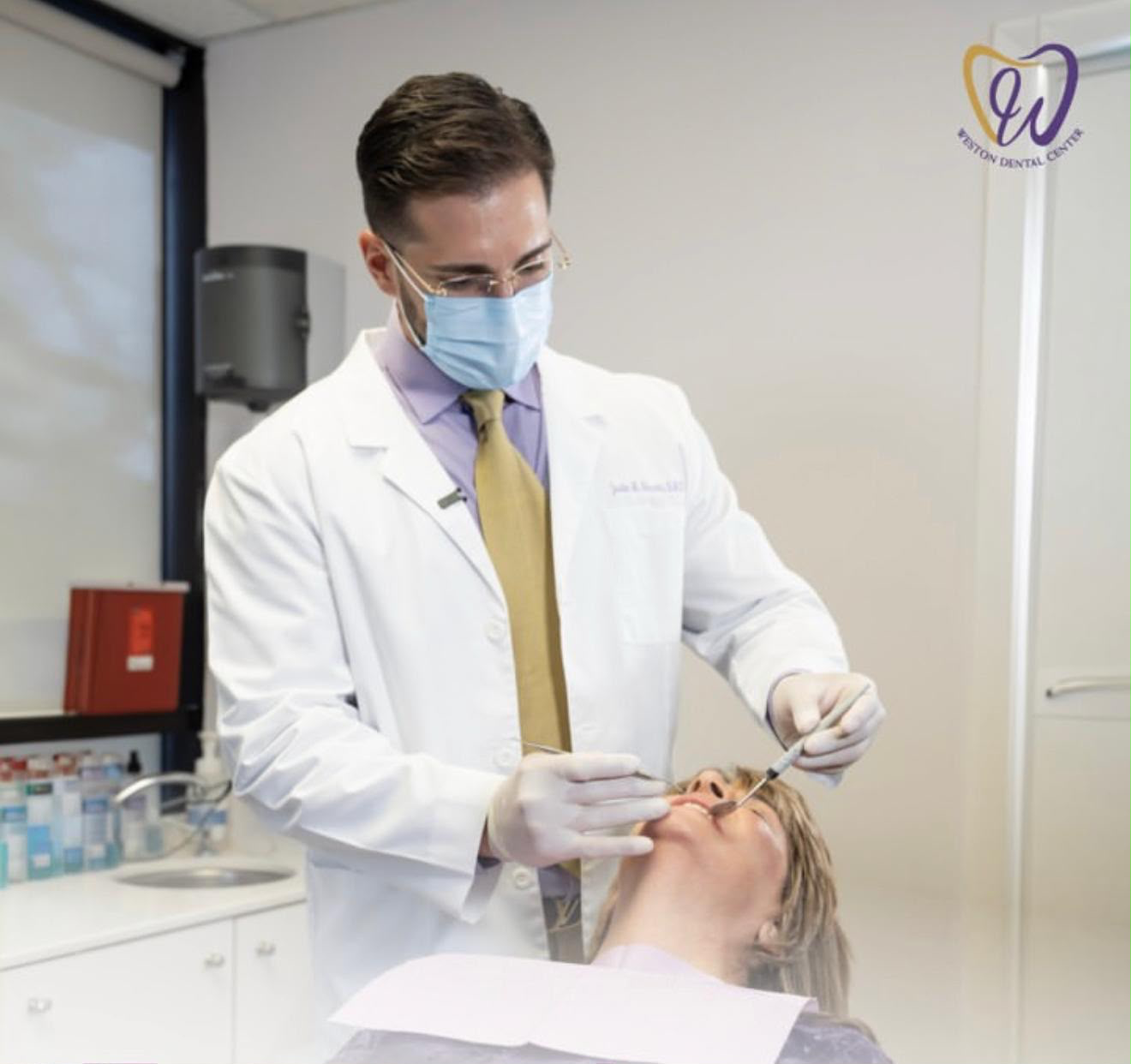 Dr. Justin Hosseini treating a patient at Weston Dental Center